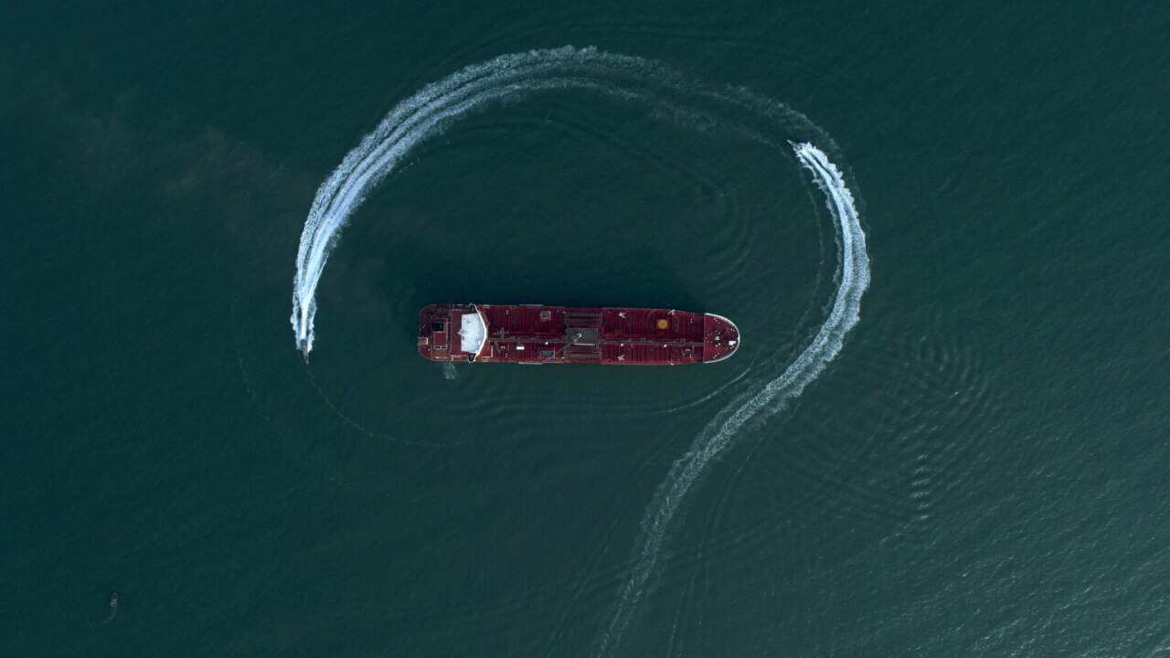 Speedboats from Iran's Revolutionary Guard circle a British-flagged oil tanker after it was seized in the Strait of Hormuz