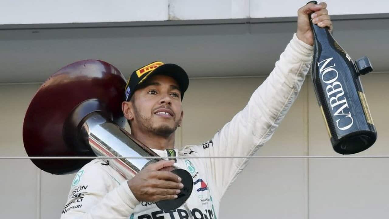 Lewis Hamilton of Mercedes celebrates during an award ceremony of the Formula 1 2018 Honda Japanese Grand Prix at the Suzuka Circuit in Suzuka City.