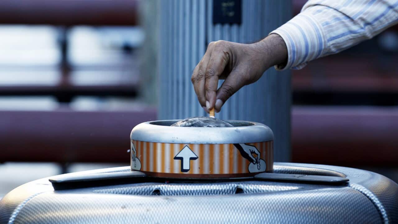 A smoker puts out a cigarette in Sydney
