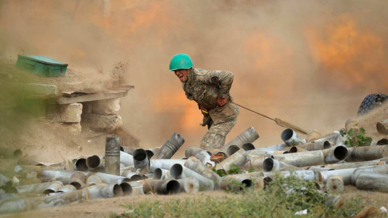 An Armenian serviceman fires a cannon towards Azerbaijan positions in the self-proclaimed Republic of Nagorno-Karabakh, Azerbaijan, 29 September, 2020.