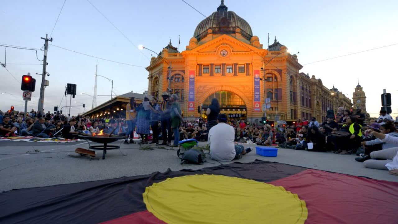 An aboriginal flag lies on the ground during a protest in Melbourne