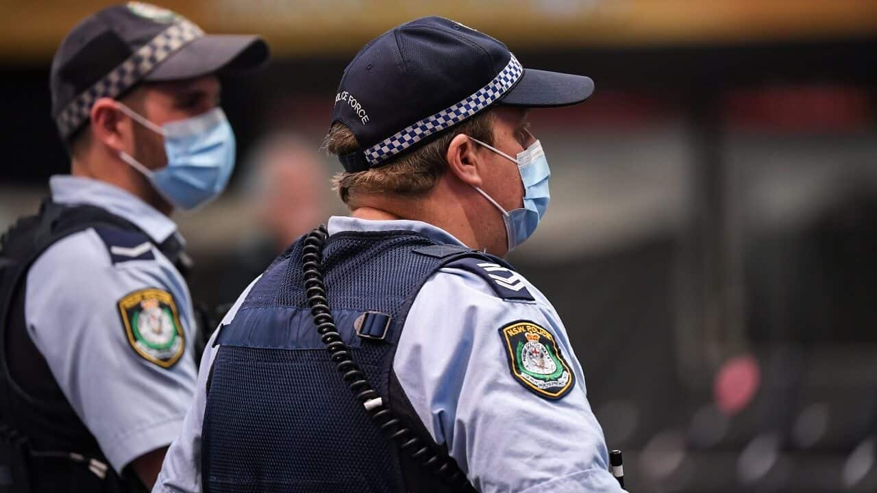 Police officers wear face masks in Sydney.