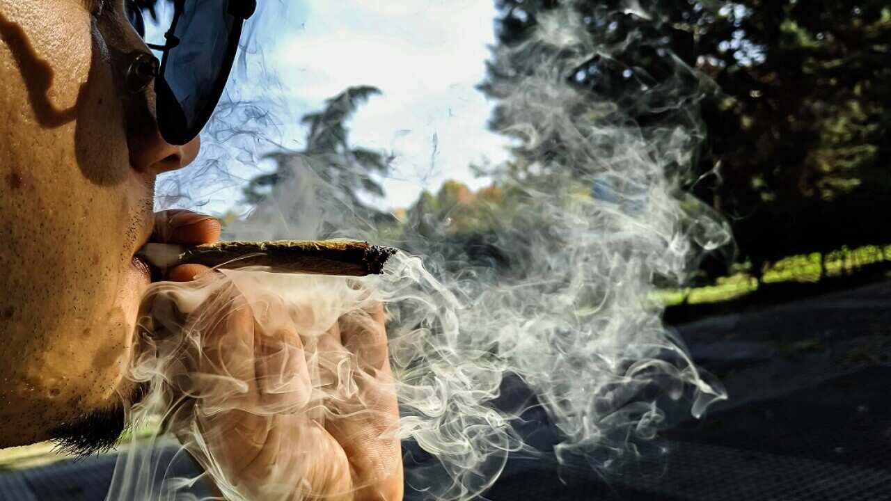 Close-Up Of Man Smoking Marijuana Joint