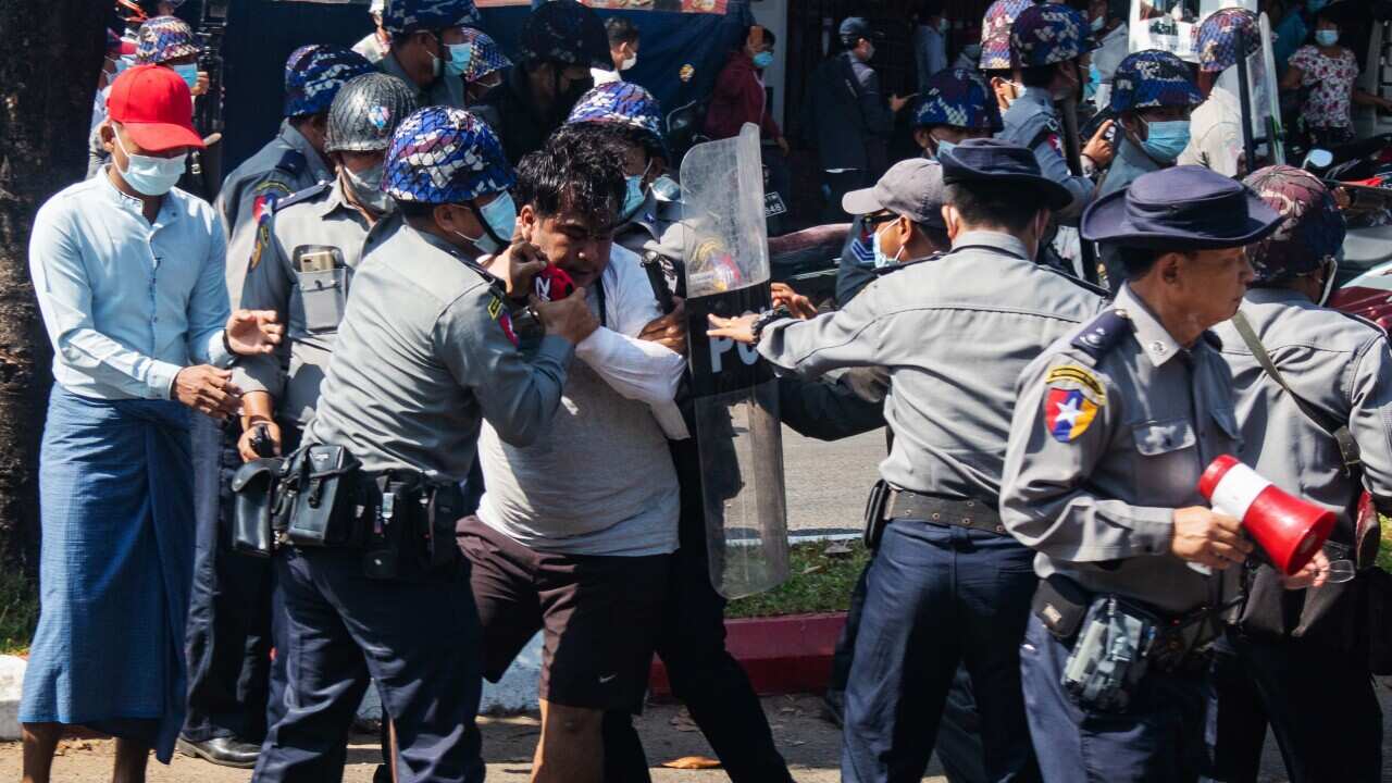 Police officers arrest a protester during a demonstration in the southwestern town of Mawlamyine, Mon State, Myanmar, 12 February 2021.