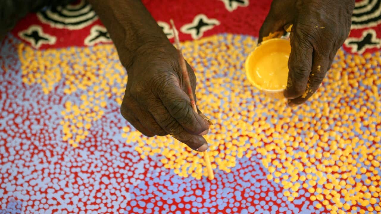 Paddy Stewart works on a dot painting
