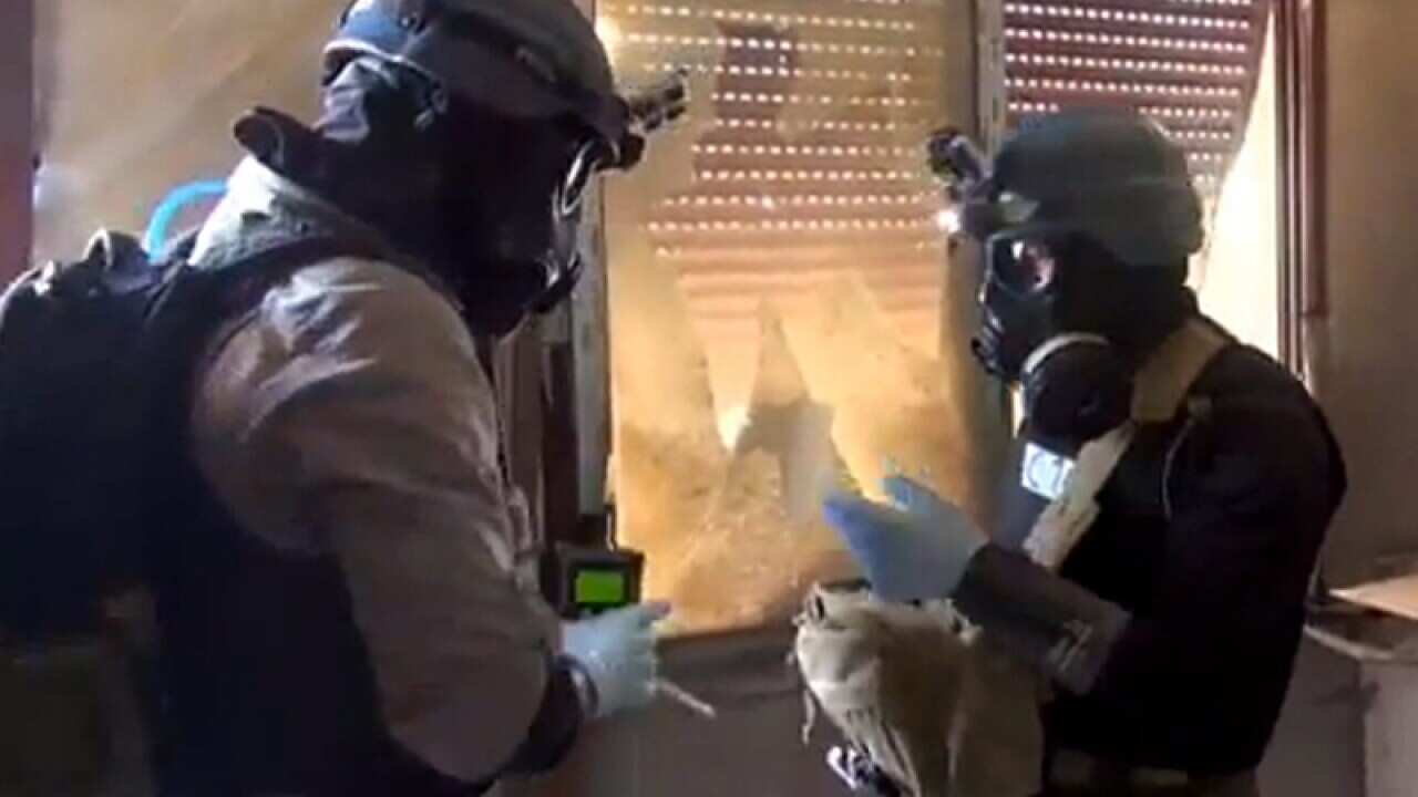 UN weapons inspectors collect samples of chemical weapons
