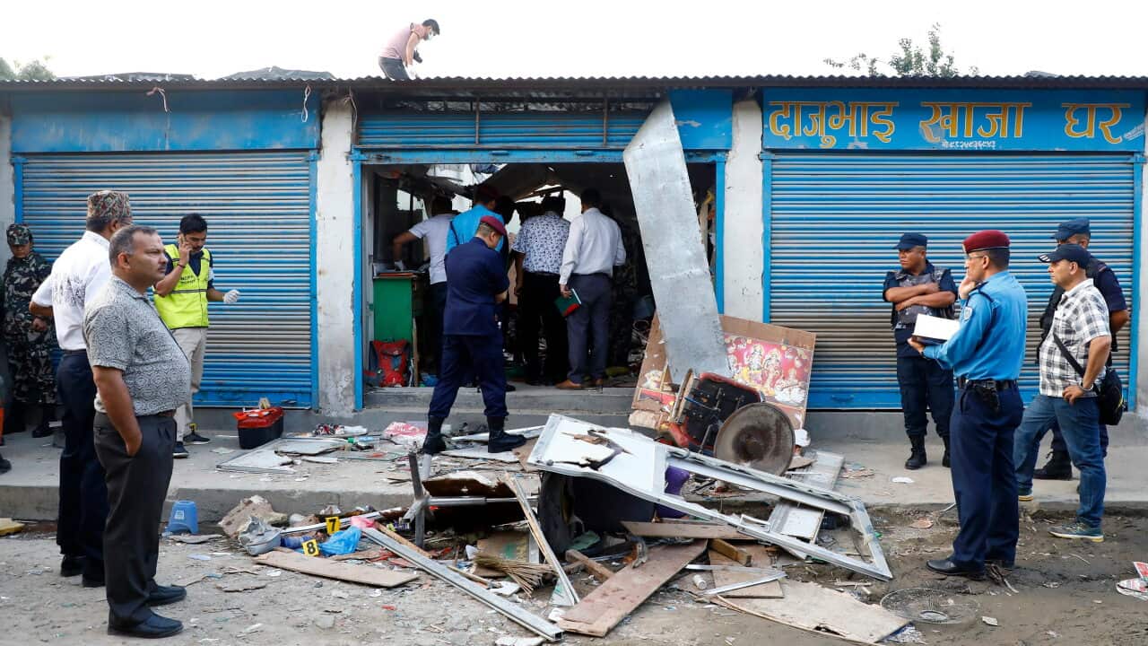 Security personnel checking and seal an explosion site in Kathmandu.