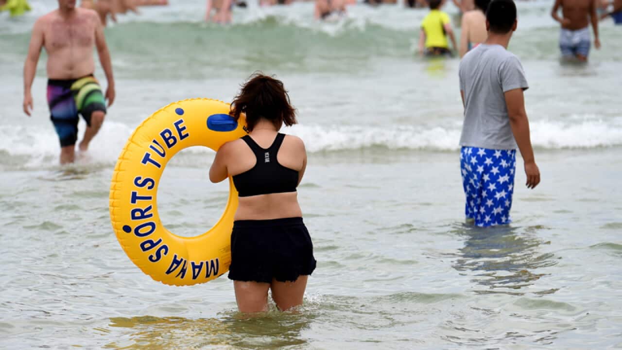 People gather in the water at Bondi Beach in Sydney