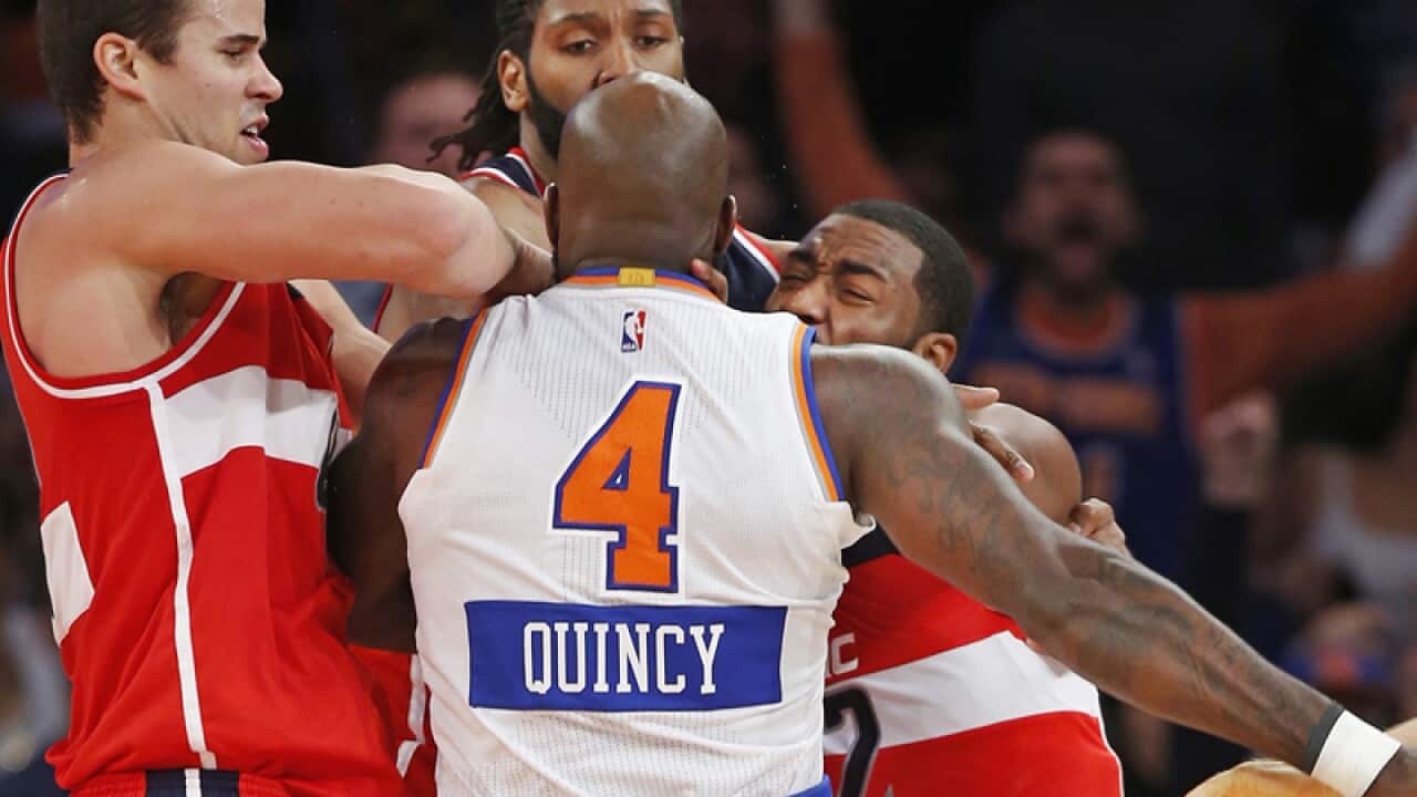 Players restrain New York Knicks forward Quincy Acy (4)