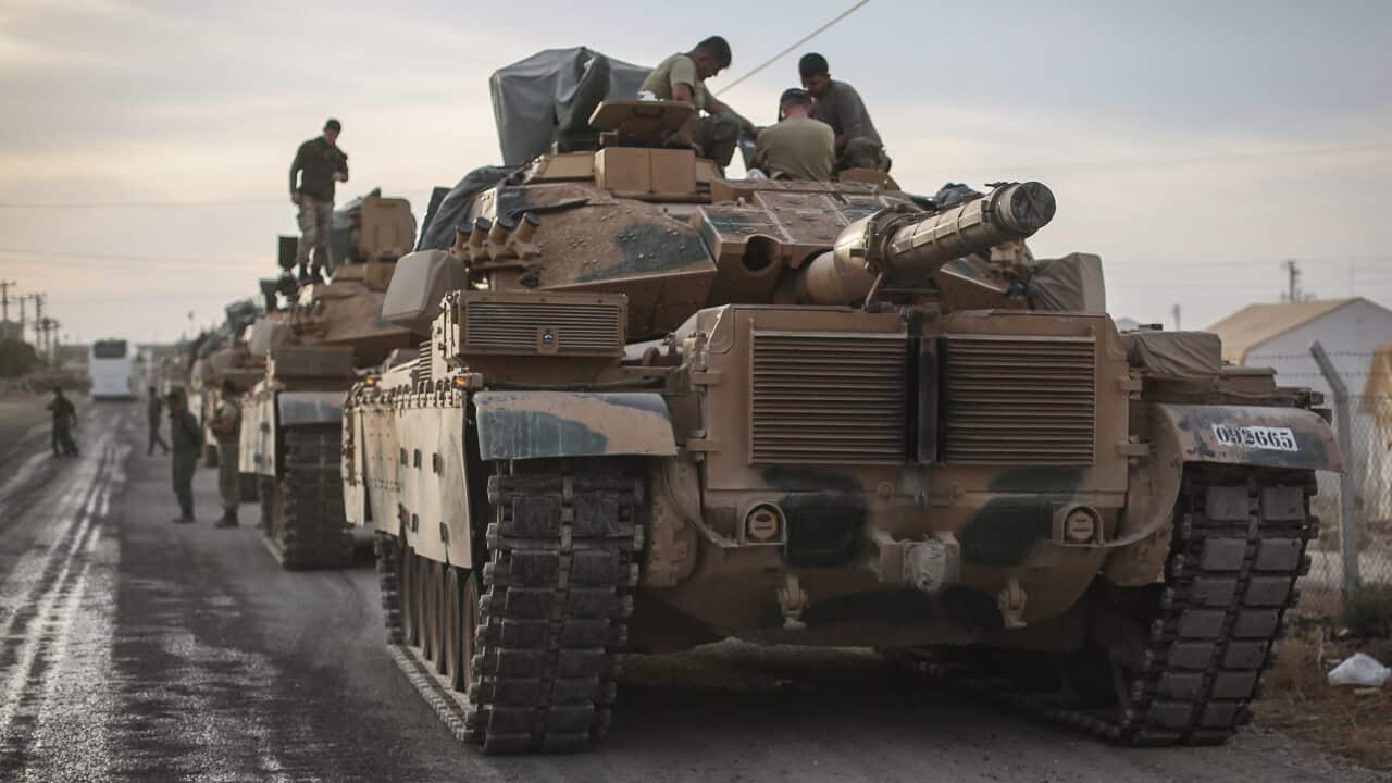 Military vehicles are deployed at a staging area for the Turkish Armed Forces along the border with the Syrian town of Tall Abyad.