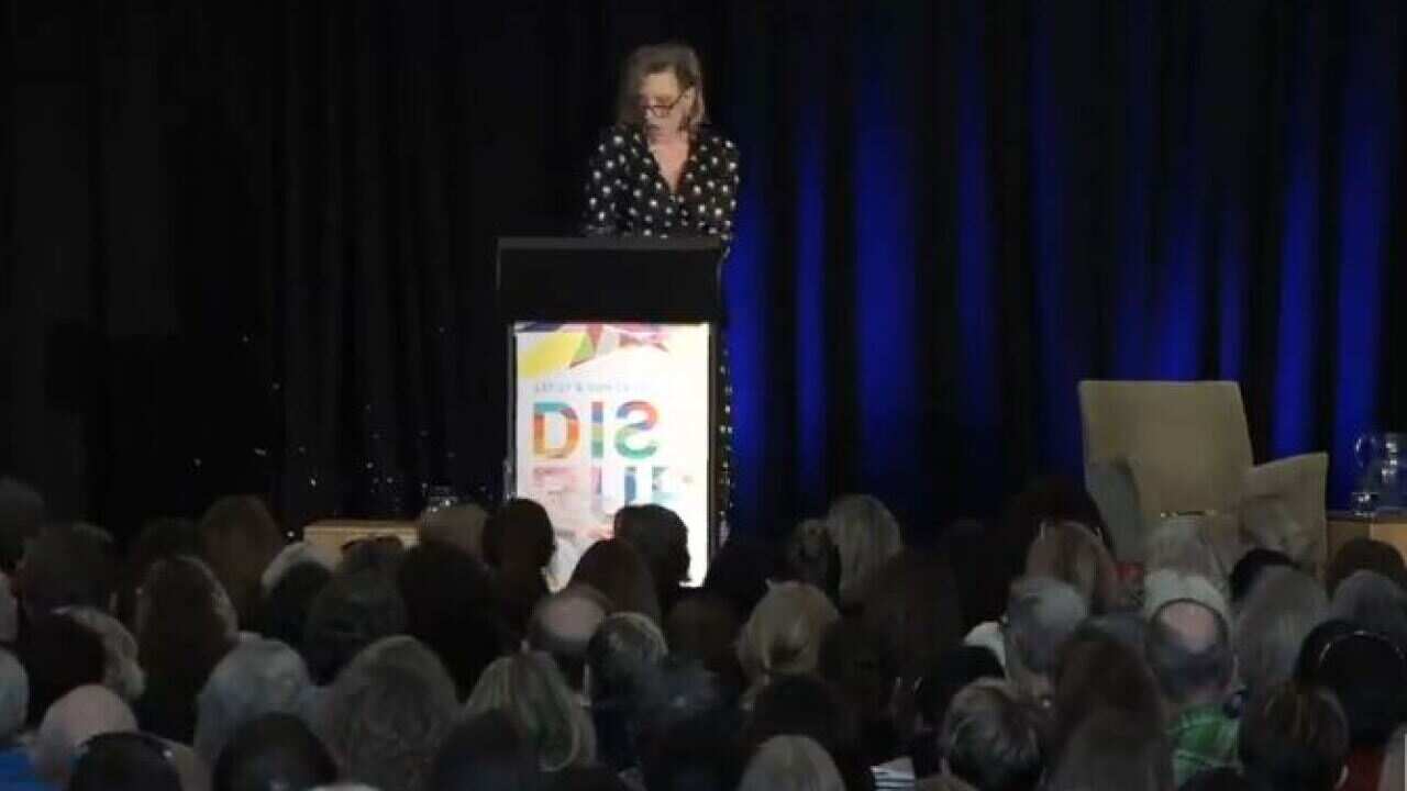 The moment after a tub of yogurt was hurled at Leigh Sales during a speech.