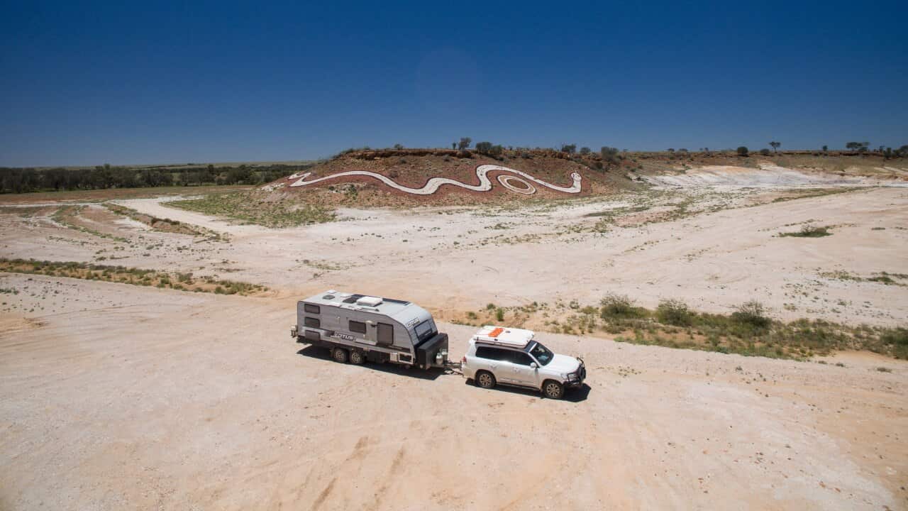 Wide shot of a caravan and 4wd in outbakc queensland