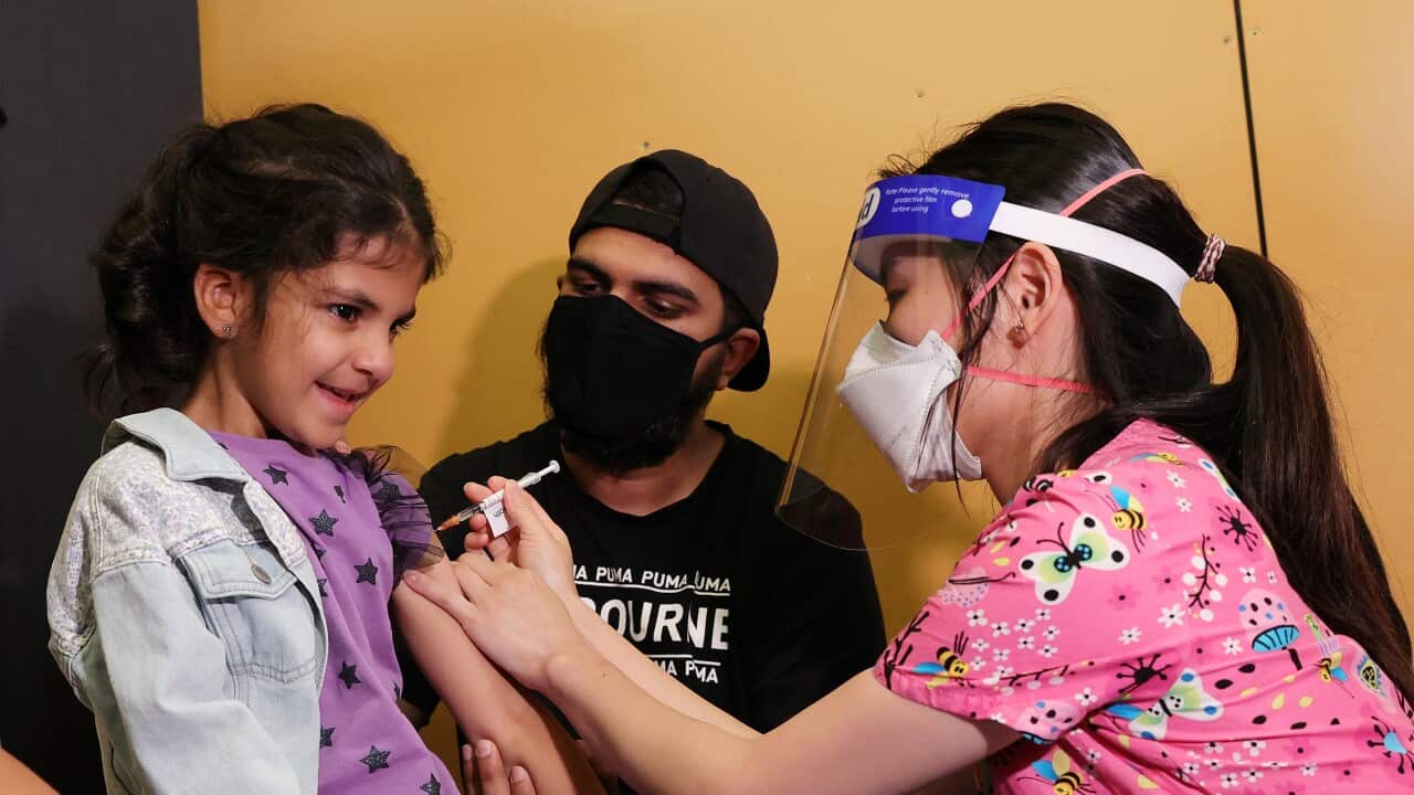 A young girl receives a vaccine.