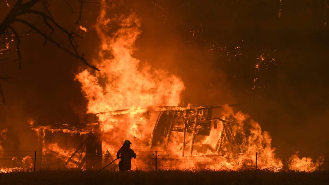NSW Rural Fire Service crews fight the Gospers Mountain Fire as it impacts a structure at Bilpin, Saturday, December 21, 2019