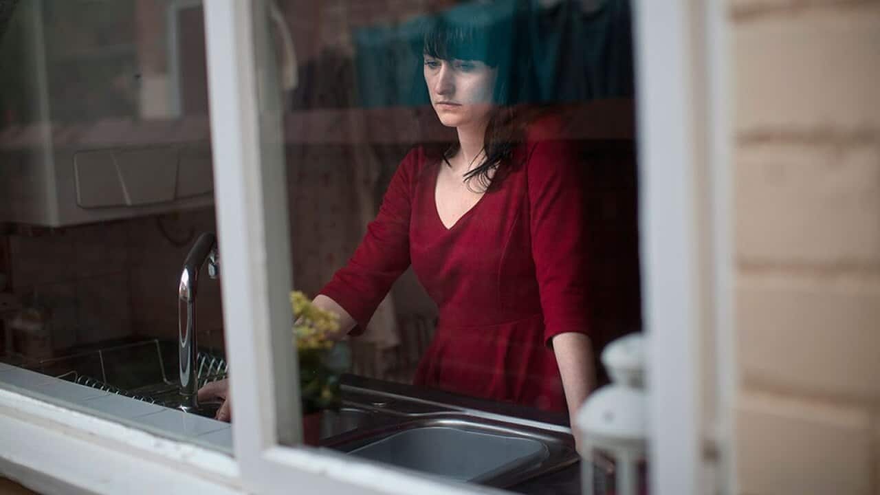 A woman stares out of the window