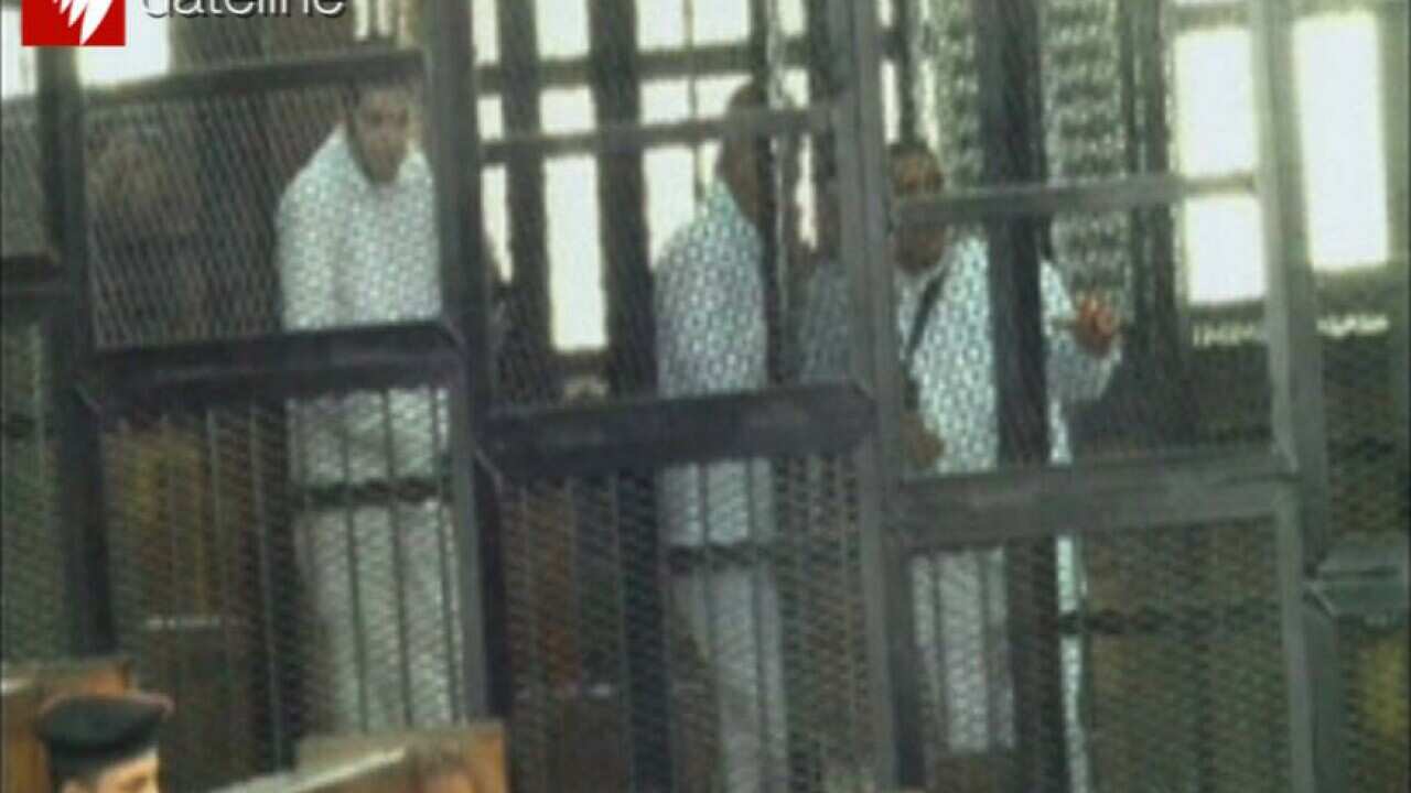 Peter Greste (centre) is seen with some of his co-accused.