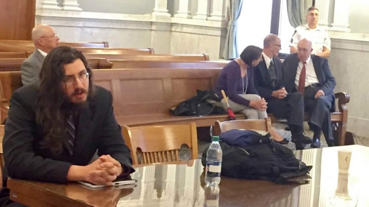 Michael Rotondo, left, sits during an eviction proceeding brought by his parents, Mark and Christina.