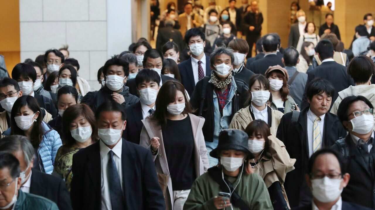 People wearing masks are seen near Umeda Station in Osaka on 7 April 2020.
