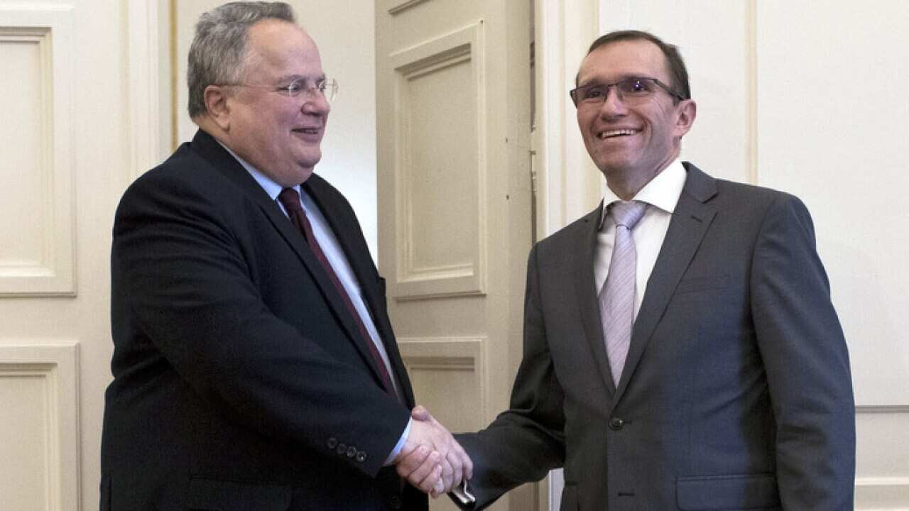 Special Adviser of the Secretary-General on Cyprus, Espen Barth Eide (R) shakes hands with Greek Foreign Minister Nikos Kotzias during their meeting in Athens