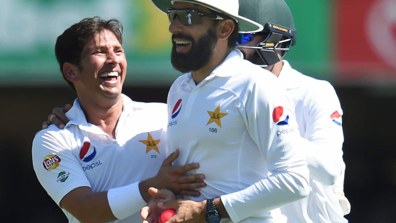 Pakistan bowler Yasir Shah (L) reacts with Misbah-ul-Haq