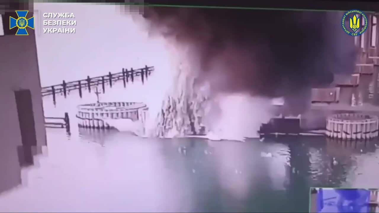 A snapshot of a bridge hit by underwater explosives.