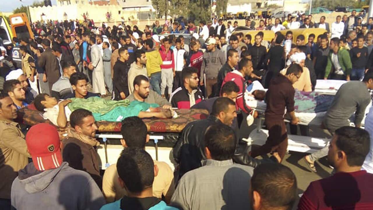 Injured people are evacuated from the scene of a militant attack on a mosque in the northern Sinai Peninsula of Egypt.