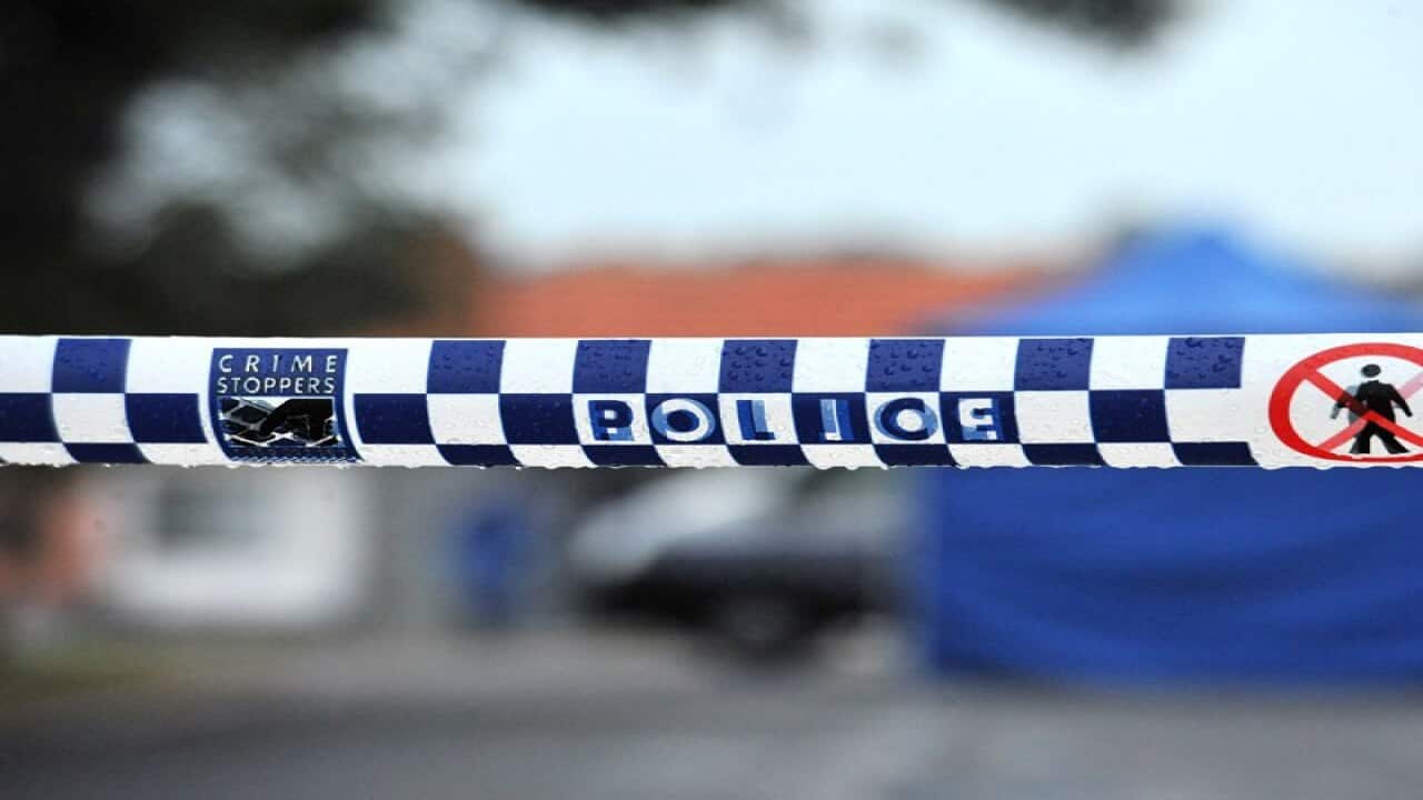 Police tape restricts access to a crime scene