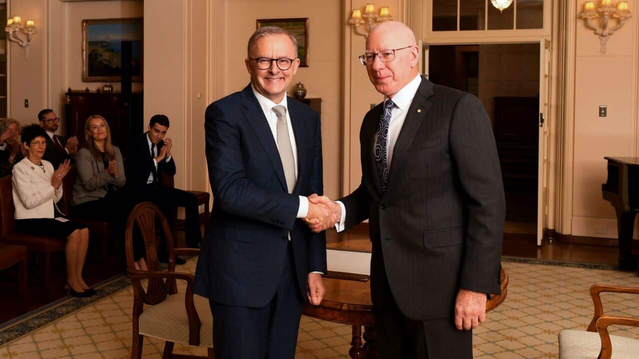 Newly sworn-in Australian Prime Minister Anthony Albanese shakes hands with Australian Governor-General David Hurley during a ceremony at Government House in Canberra,