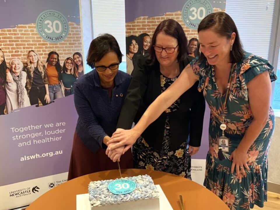 Researchers from the ALSWH cutting a cake to mark 30 years of their research into women's health