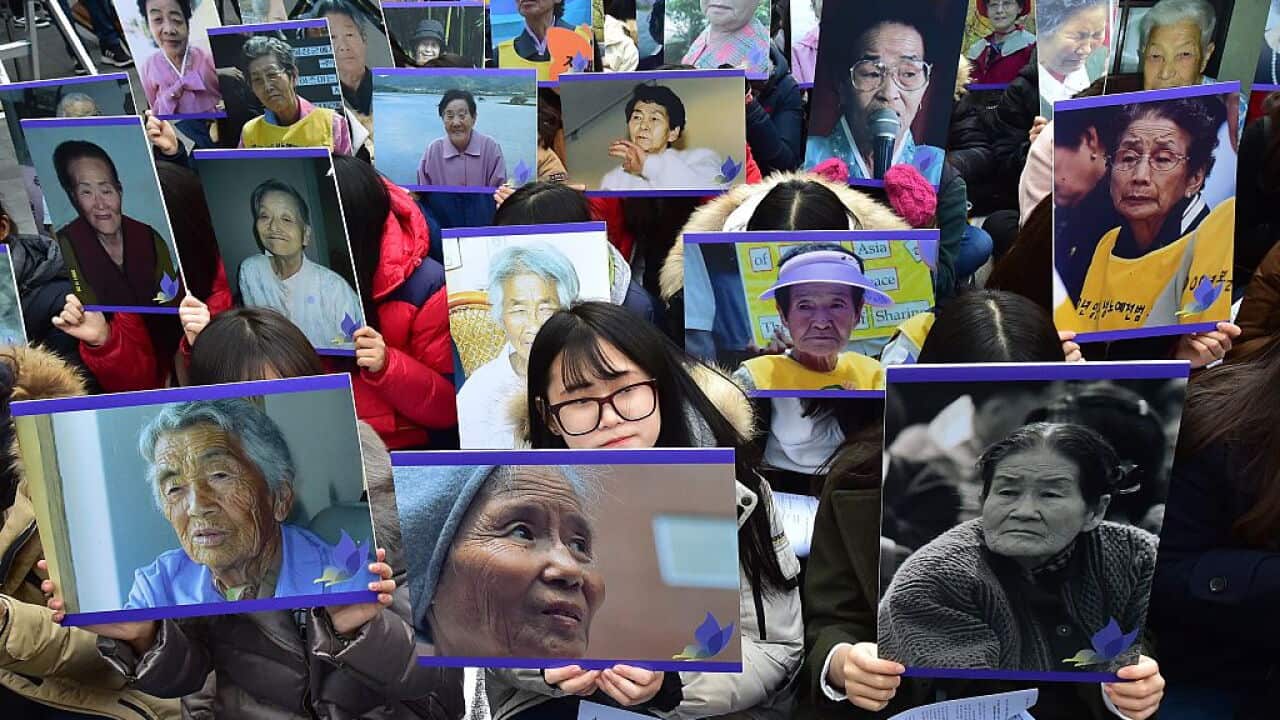 South Korean supporters hold portraits of former "comfort women", who were forced into wartime sexual slavery for Japanese soldiers