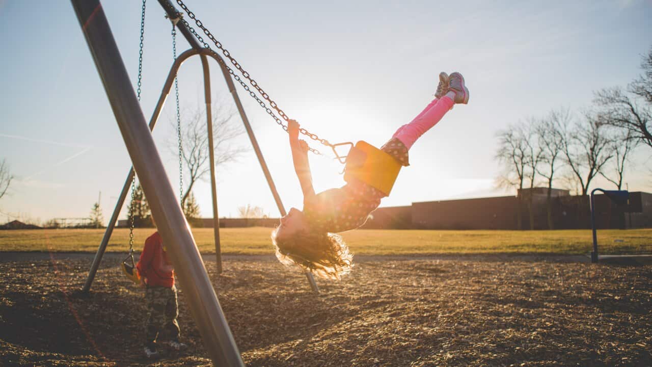 Children playing on a swing set