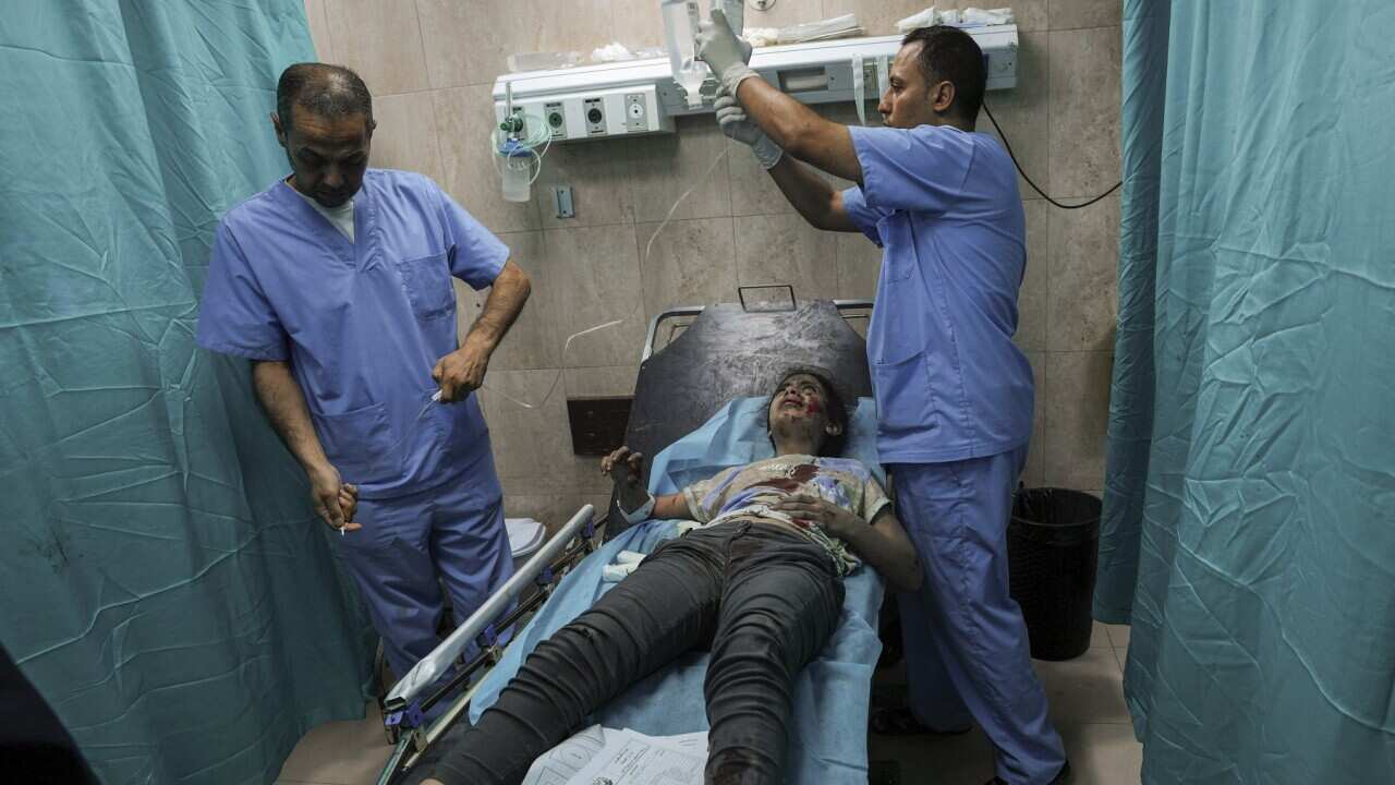 A Palestinian girl wounded during an Israeli airstrike receives medical treatment at al-Aqsa Hospital in Deir el-Balah, central Gaza Strip (AAP).jpg