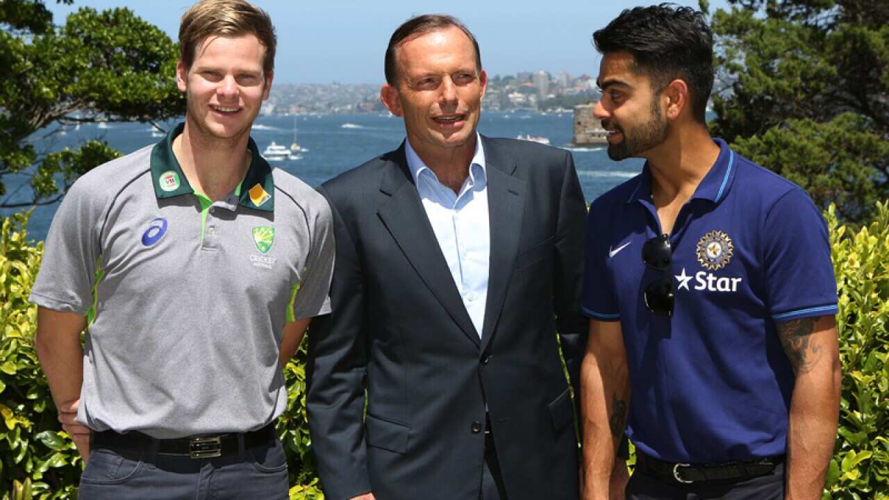 Prime Minister Tony Abbott (C) with Steve Smith and Virat Kohli