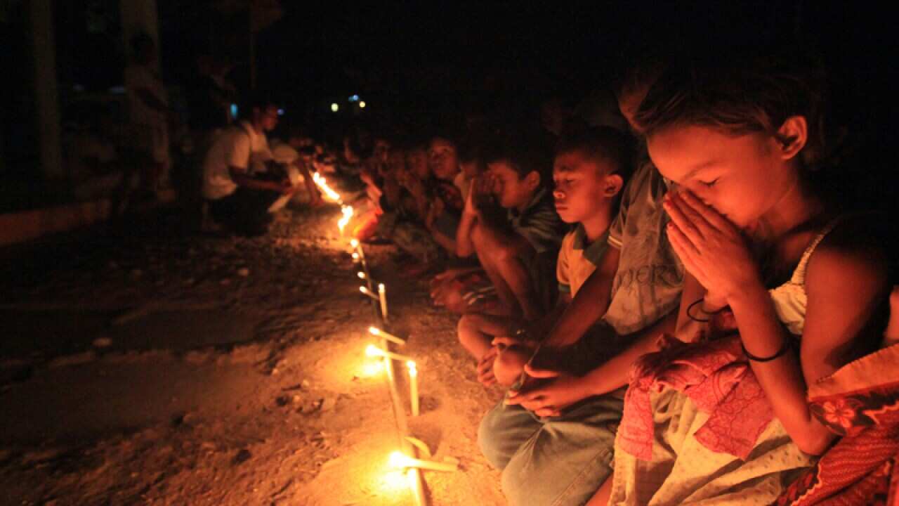 The children of Balibo light candles