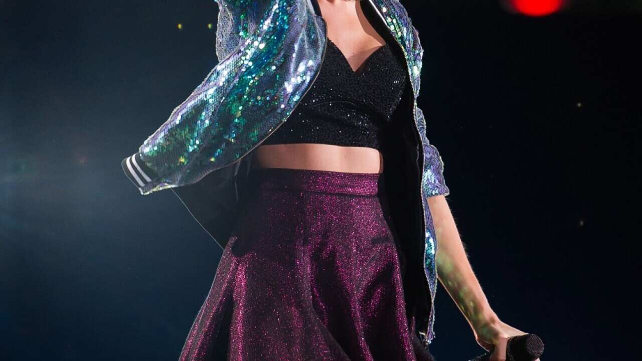 Singer Taylor Swift has told the Australia media to "take it down a notch"