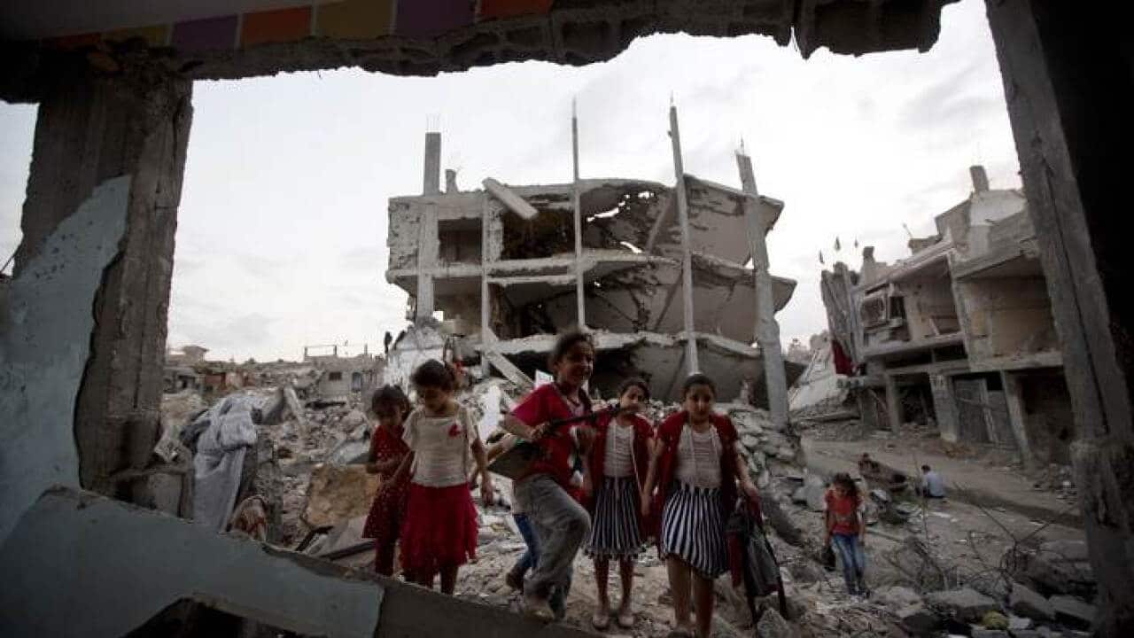 children_stand_in_the_rubble_of_gaza_aap_larger.jpg
