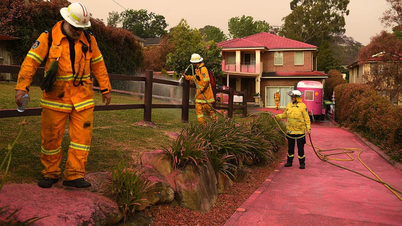 Chemical fire retardant covers the houses on Canoon Rd and Barwon Avenue South Turramurra as firefighters prepare.