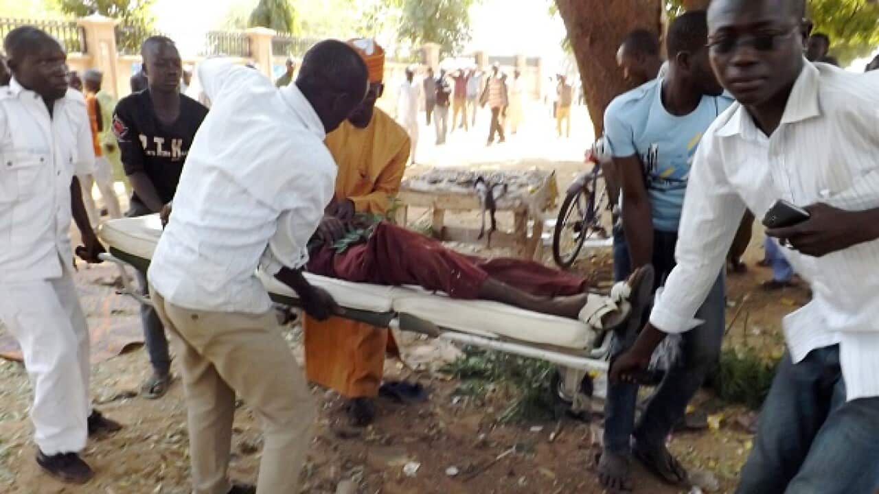 Aid workers evacuate a man injured in a suicide blast in the northeastern Nigerian city of Potiskum on February 1, 2015. (AMINU ABUBAKAR/AFP/Getty Images)