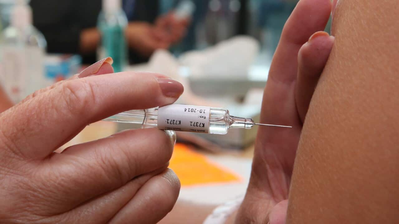 A person receives a flu vaccination