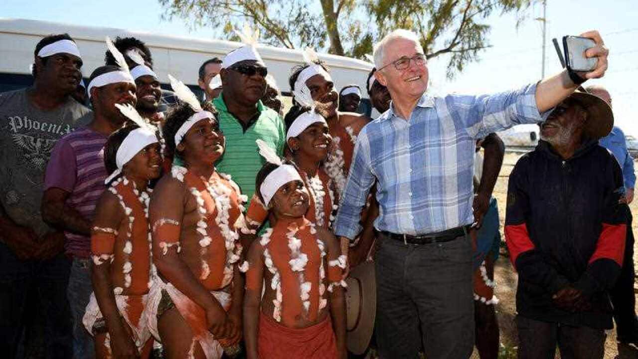 Prime Minister Malcolm Turnbull meets with a local Indigenous dance troupe after arriving at Tennant Creek airport, in the Northern Territory, Sunday, July 22, 2018.