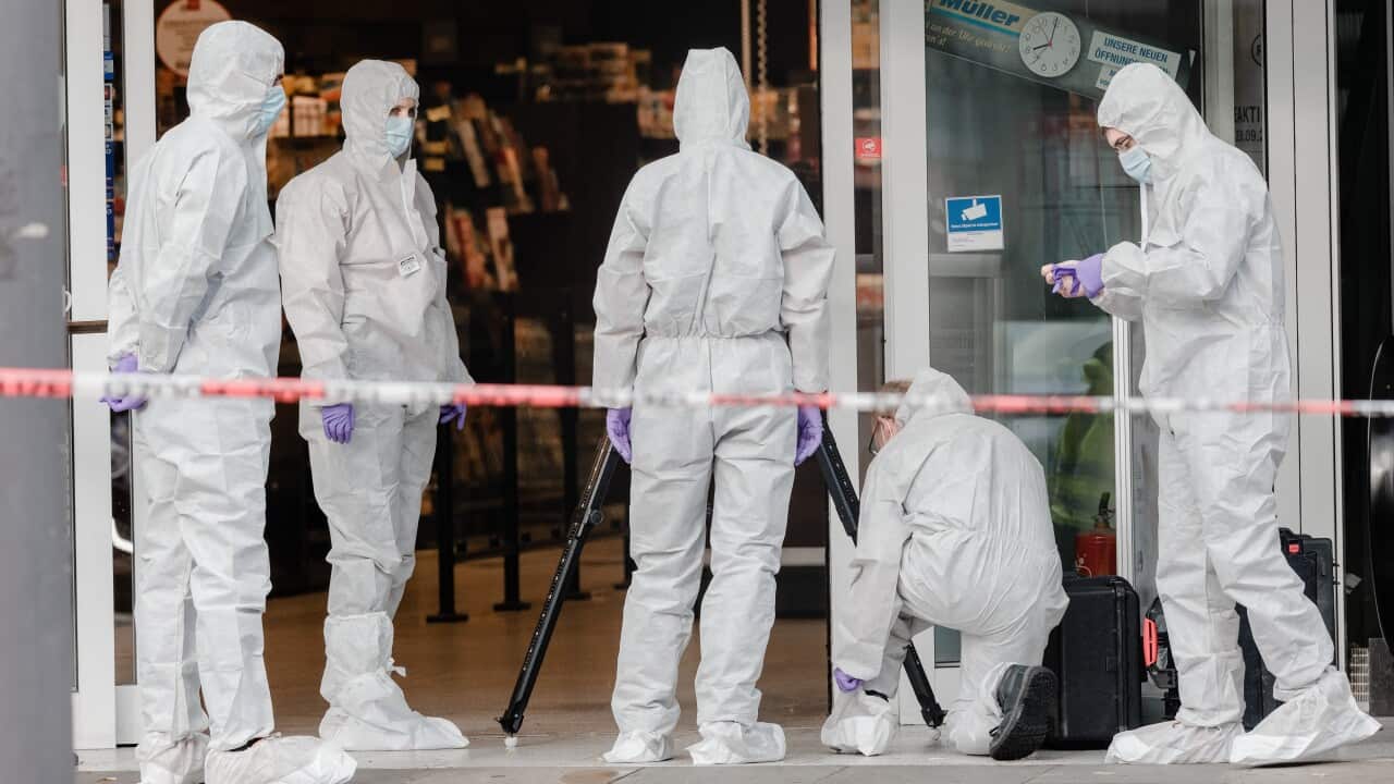 Police secure traces at the site of the incident after a knife attack at a supermarket in Hamburg, Germany.
