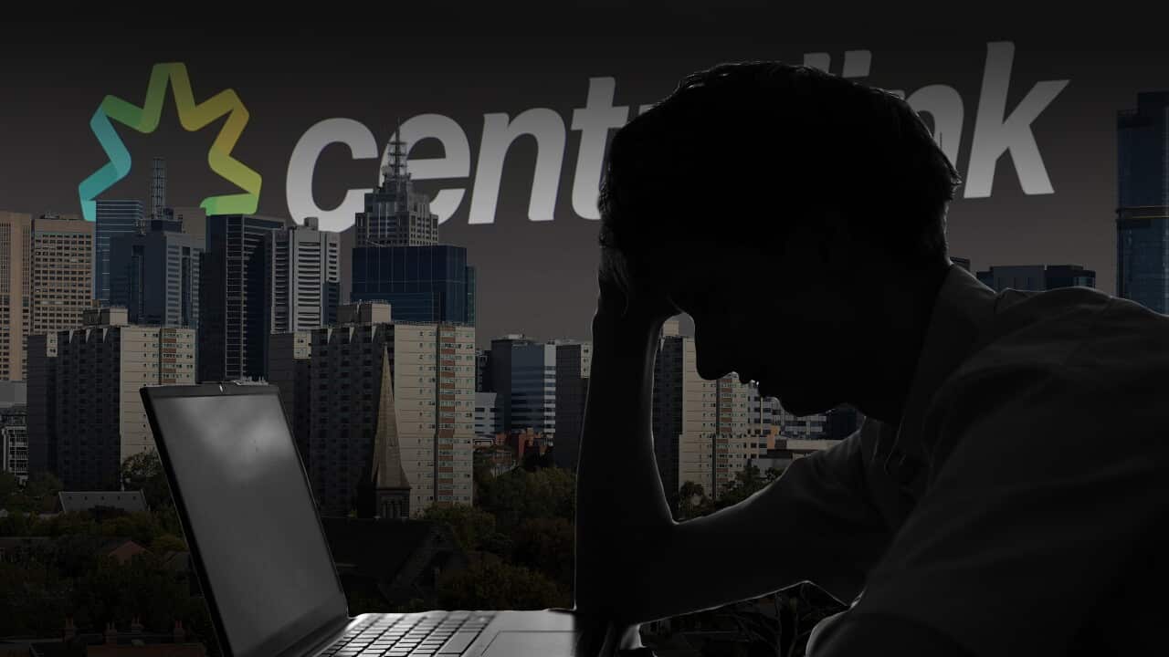 Silhouetted person with laptop in front of Centrelink logo and city skyline.