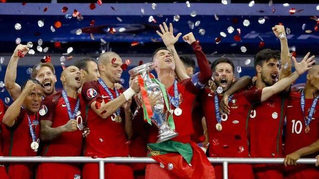 Portugal's Cristiano Ronaldo holds the trophy at the end of during the Euro 2016 final soccer match between Portugal and France. (AAP)