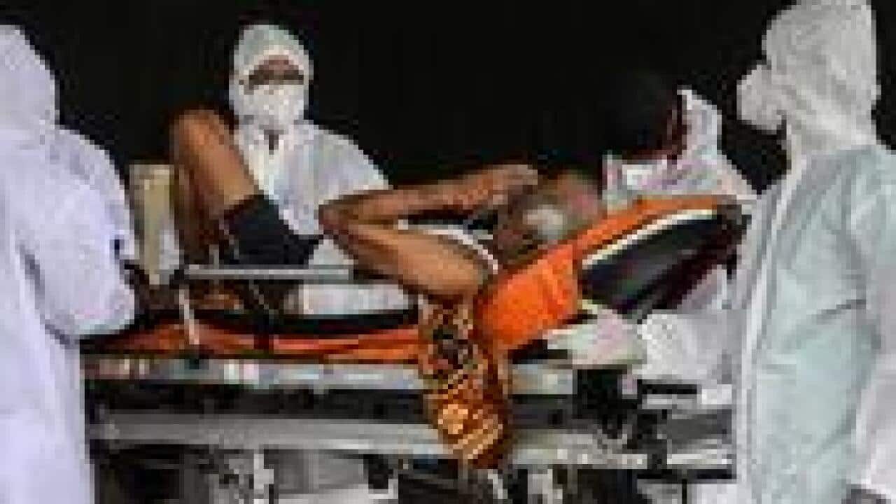 A suspected COVID-19 positive patient waits outside a health centre in Mumbai, India, 19 April 2021