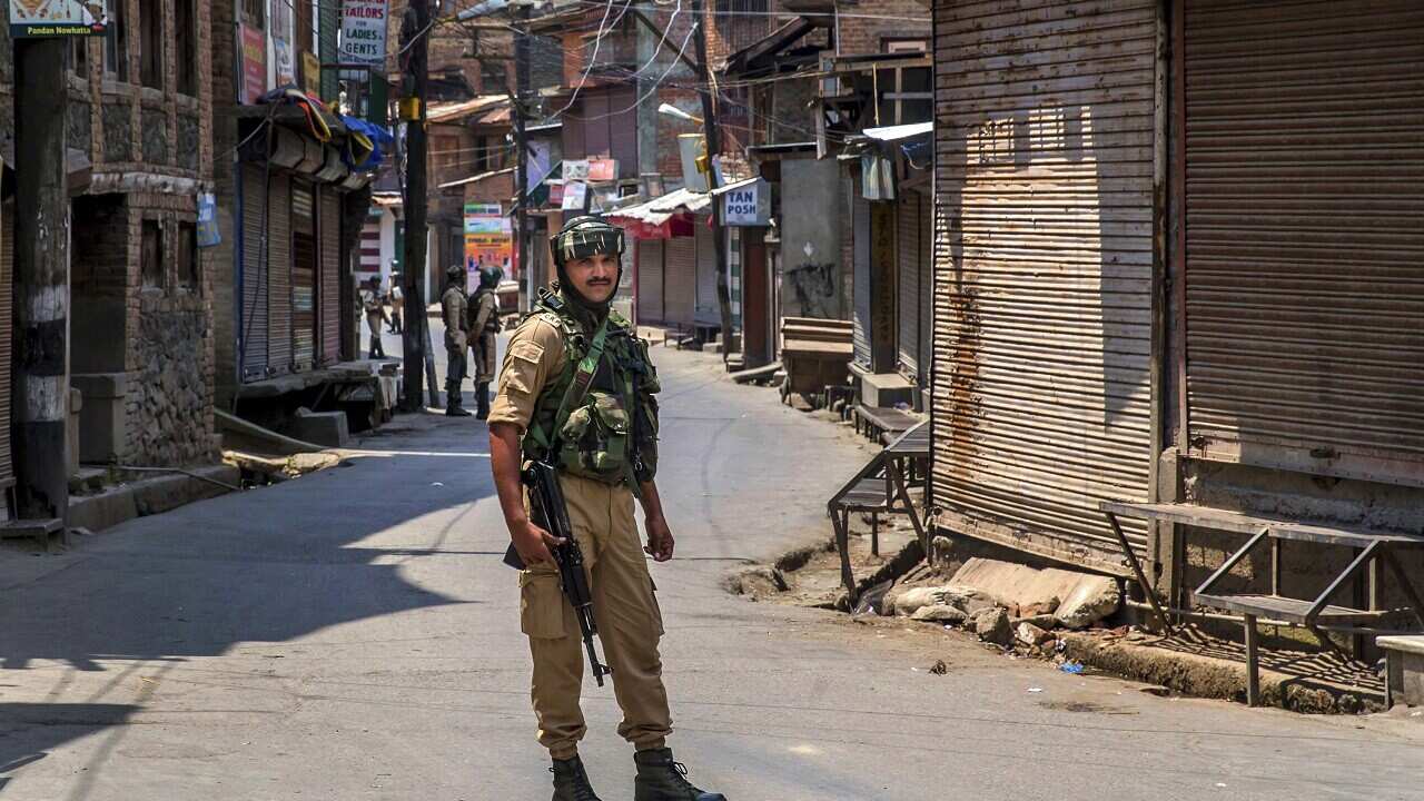 Indian paramilitary soldier stands guard in Srinagar.