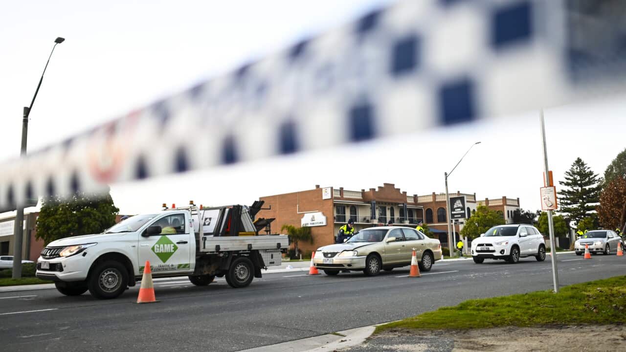NSW Police officers check cars crossing from Victoria into New South Wales (NSW) at a border check point in the NSW-Victoria border town of Albury.