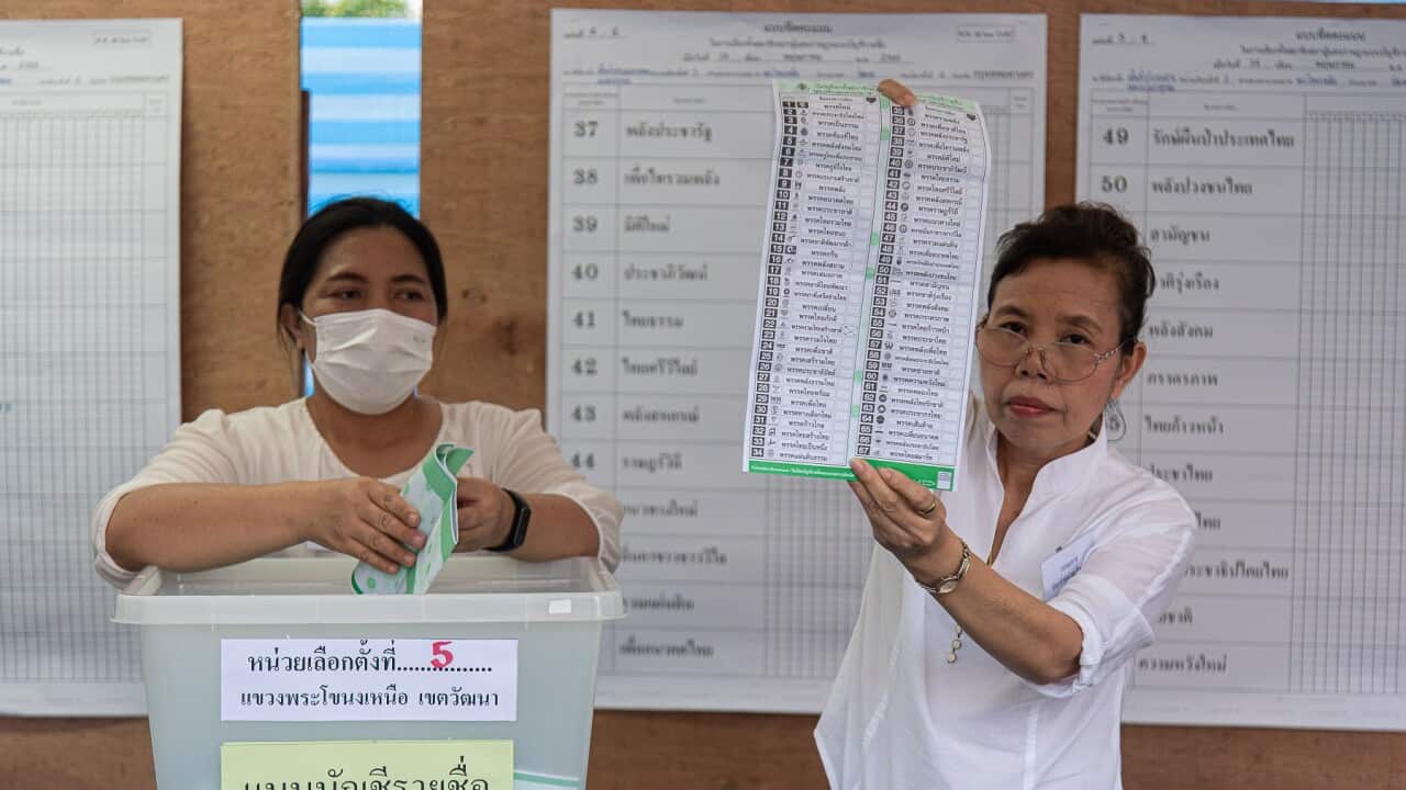Thai poll station officials count votes at a polling station