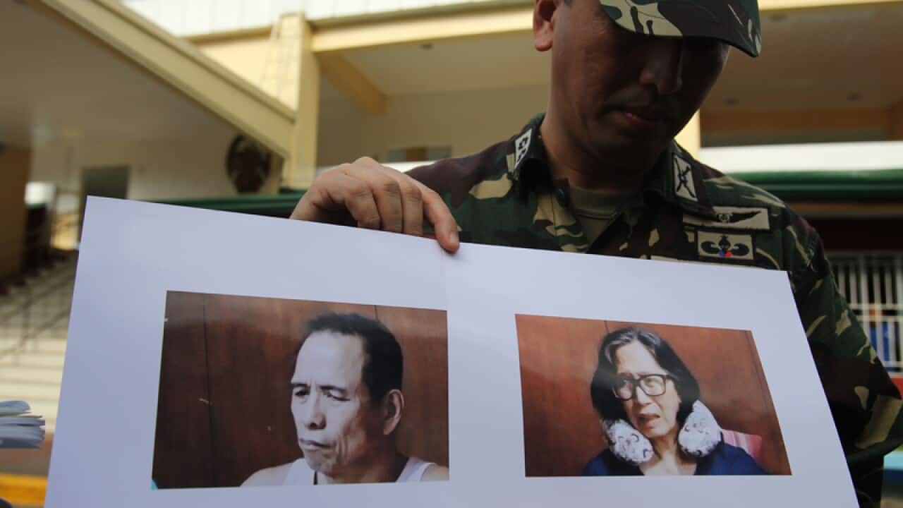 Philippine Lt. Col. Ramon Zagala with pictures of communist leaders