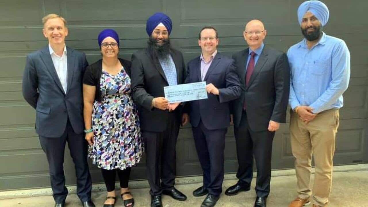 Julian Hill MP, Shayne Neumann MP, with Jatinder Kaur (manager Sahara House) and members from the Brisbane Sikh temple receiving a donation of $8887 from the CEO of Key Assets in December 2018