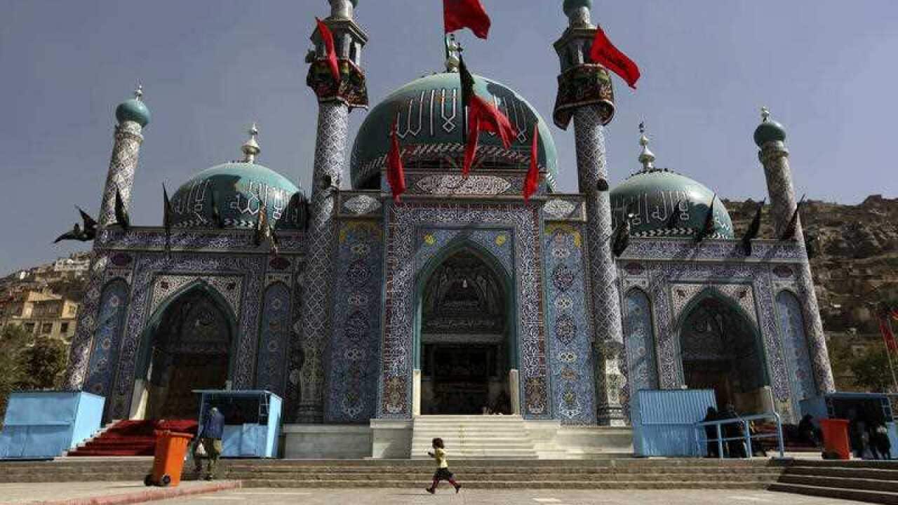 File photo : An Afghan Shiite girl runs in front of the Karti Sakhi shrine during a commemoration of Ashoura in Kabul, Afghanistan